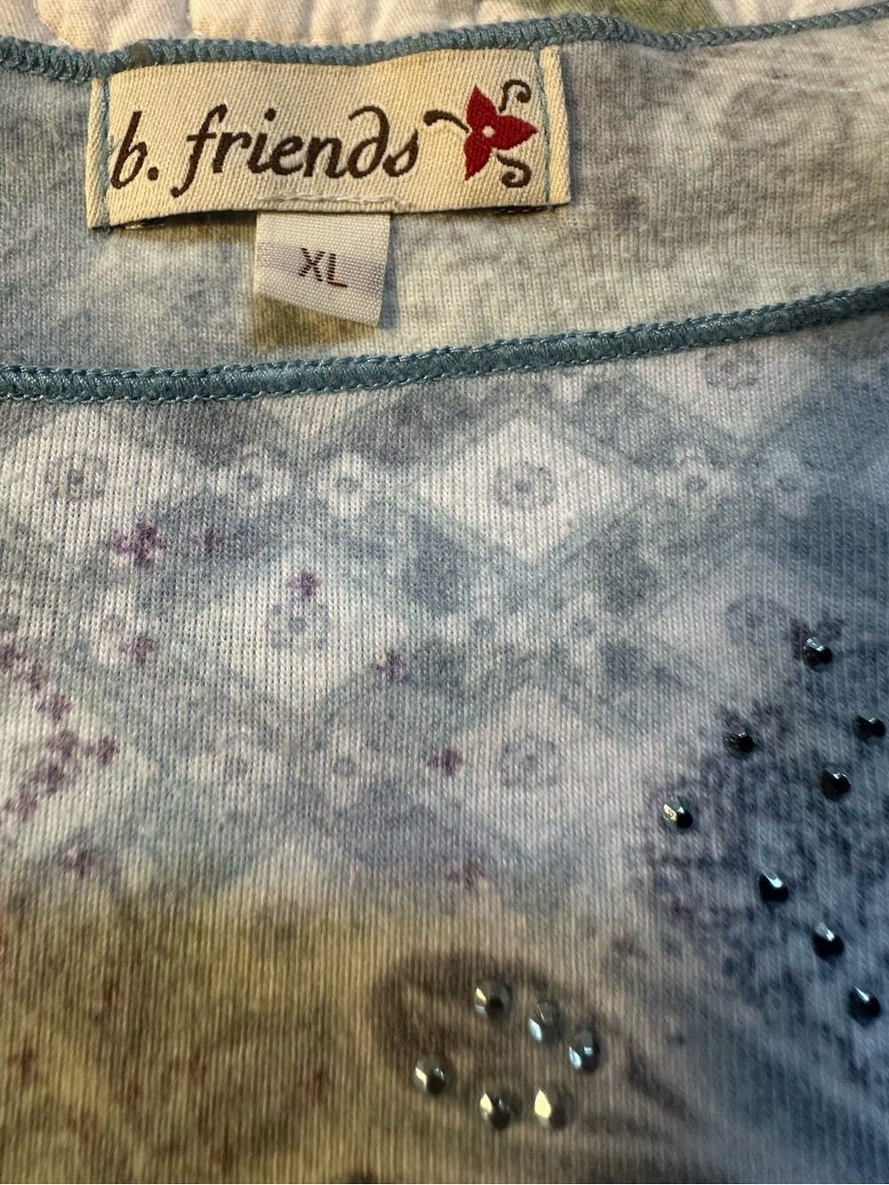 Light Blue Floral Scoop Neck Women's Top with a front flower with gem accents. - Picture 8 of 9